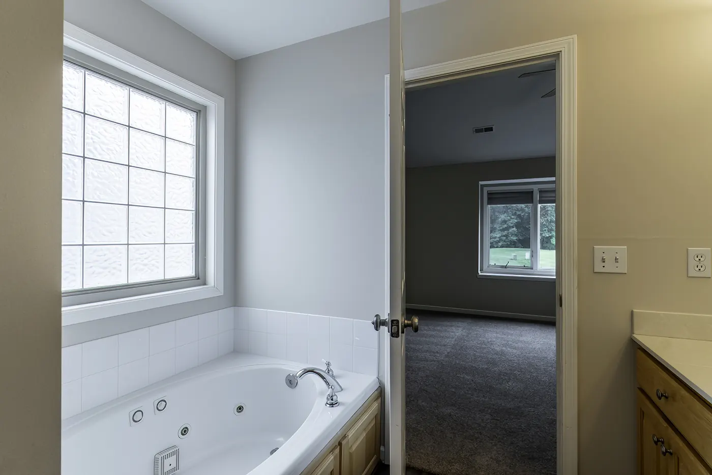 Primary bathroom at 1906 Kelleys Landing, Fort Wayne IN showing jetted tub and vanity