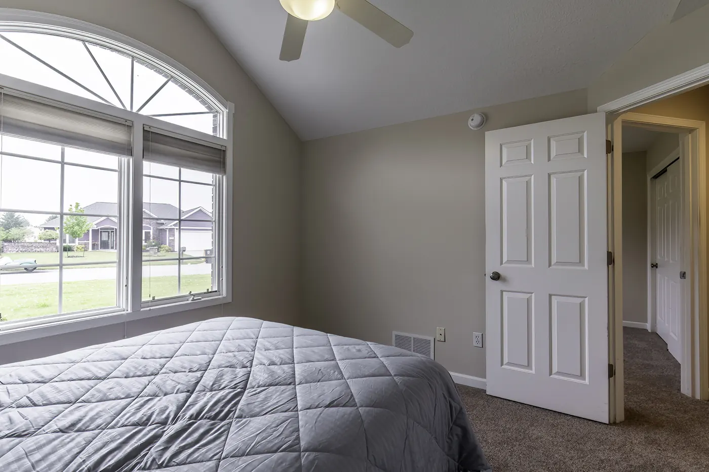 Primary bedroom with arched window