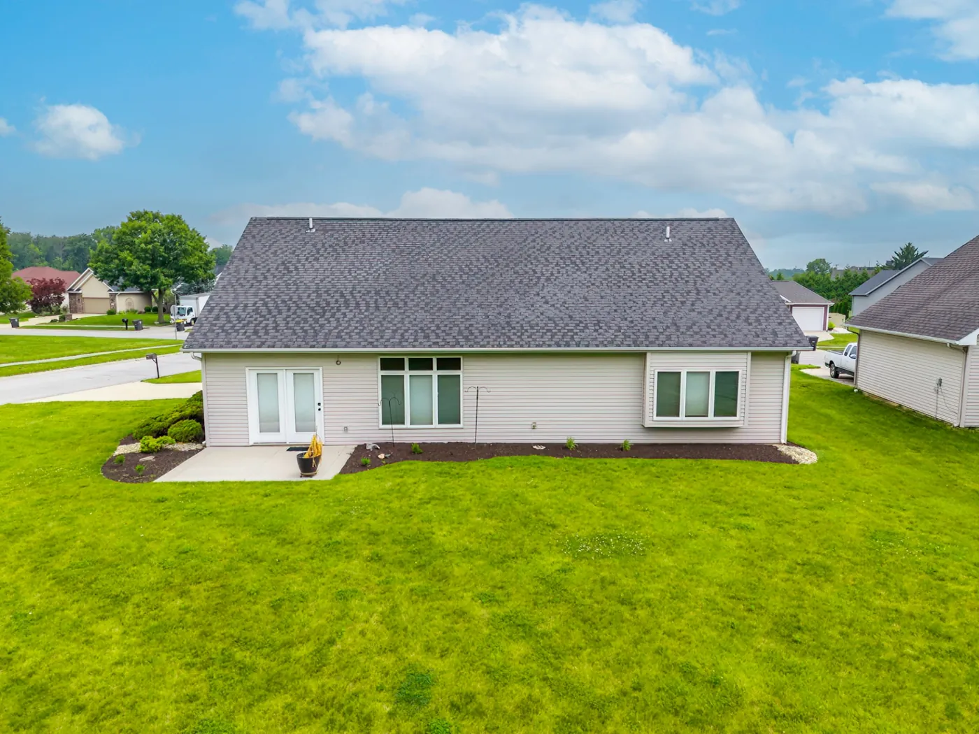 Aerial back-of-home view of 1906 Kelleys Landing, Fort Wayne IN with open backyard space