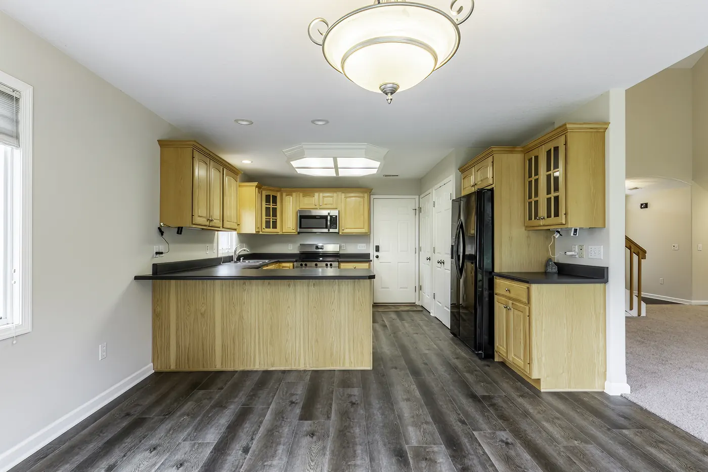 View from dining area toward kitchen and staircase at 1906 Kelleys Landing, Fort Wayne IN