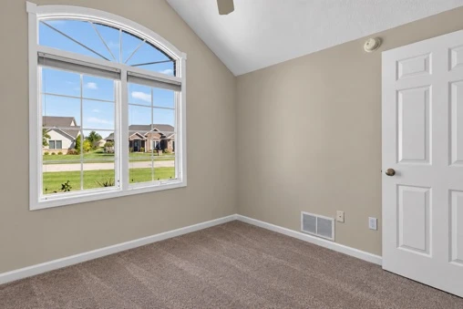 Main Level · Bedroom with arched window at 1906 Kelleys Landing
