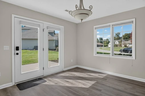 Dining area with wood-look flooring and patio access