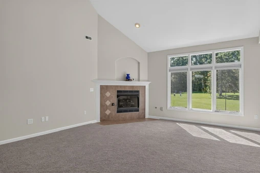 Main Level · Great room fireplace and large windows at 1906 Kelleys Landing