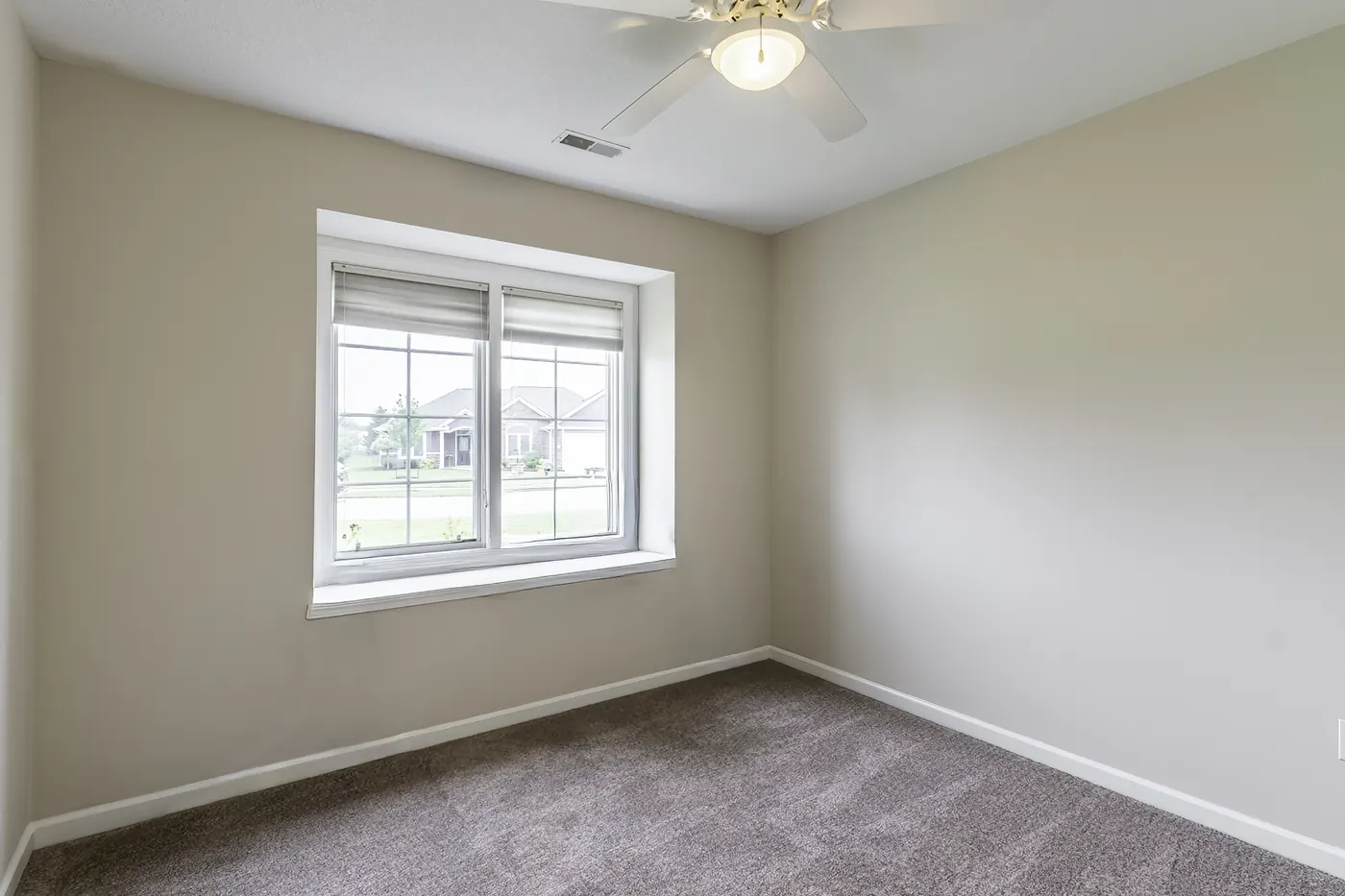 Bedroom at 1906 Kelleys Landing, Fort Wayne IN with large window overlooking the neighborhood