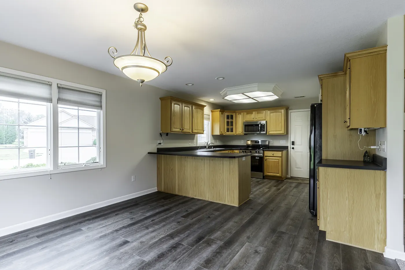 Dining area looking toward the kitchen at 1906 Kelleys Landing, Fort Wayne IN with pendant lighting